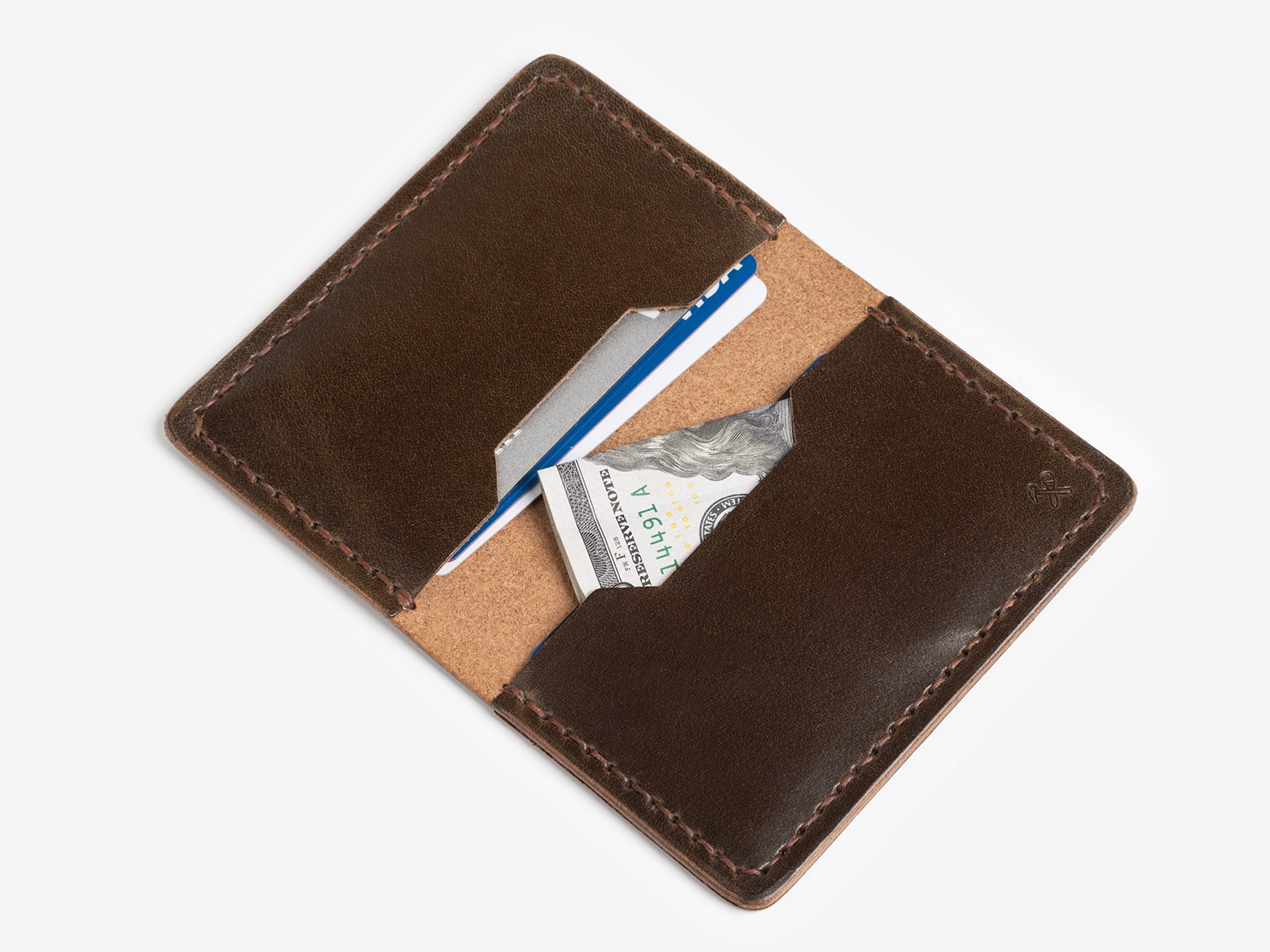 A brown leather wallet open to reveal a blue credit card, a white card, and a folded U.S. twenty-dollar bill against a white background.